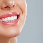 Donna sorride e mostra denti bianchi e sani